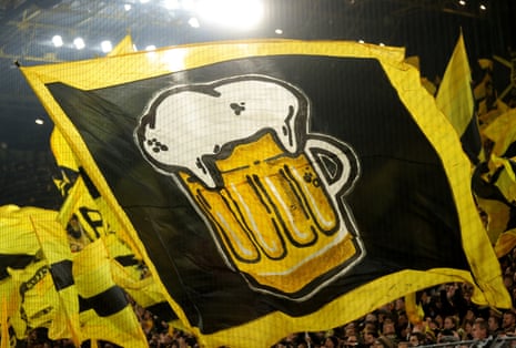 Borussia Dortmund supporters wave flags ahead of the German Bundesliga soccer match between Borussia Dortmund and FC Bayern Munich.