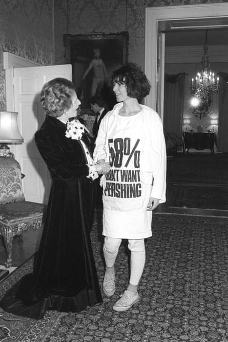 Then prime minister Margaret Thatcher shaking hands with designer Katharine Hamnett, who is wearing her “58% don’t want pershing” protest T-shirt, 1984
