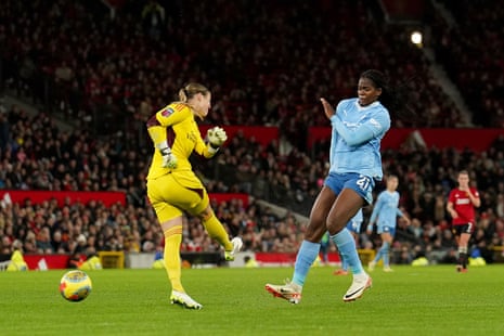 Manchester City's Khadija Shaw (right) charges down Mary Earps’ clearance to put City 3-1 up.