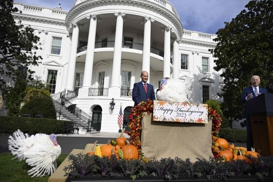 President Joe Biden (right) speaks as he pardons the national Thanksgiving turkeys, Liberty and Bell, during a ceremony at the White House on Monday