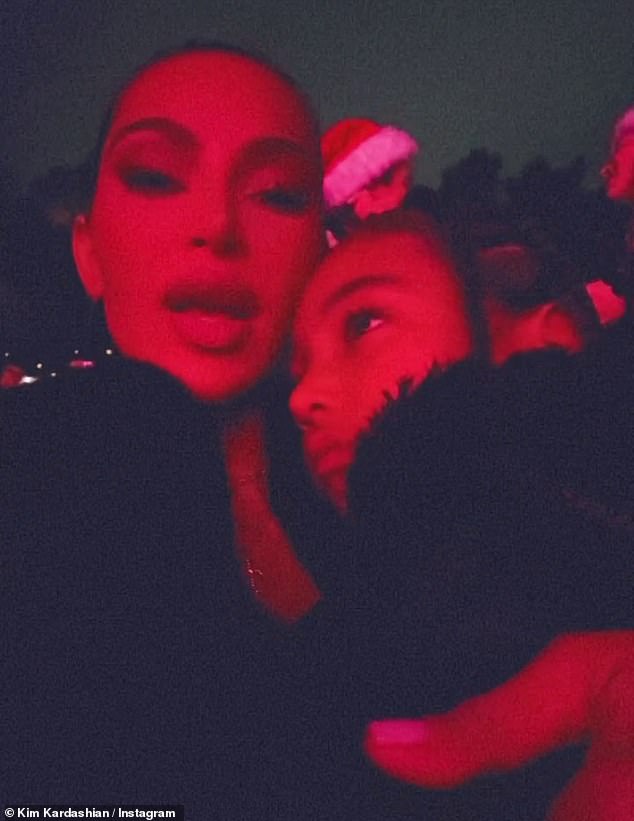 Holiday spirit:  Kim Kardashian got into the holiday spirit Friday, attending Mariah Carey 's Merry Christmas One And All! show at the Hollywood Bowl with her daughters