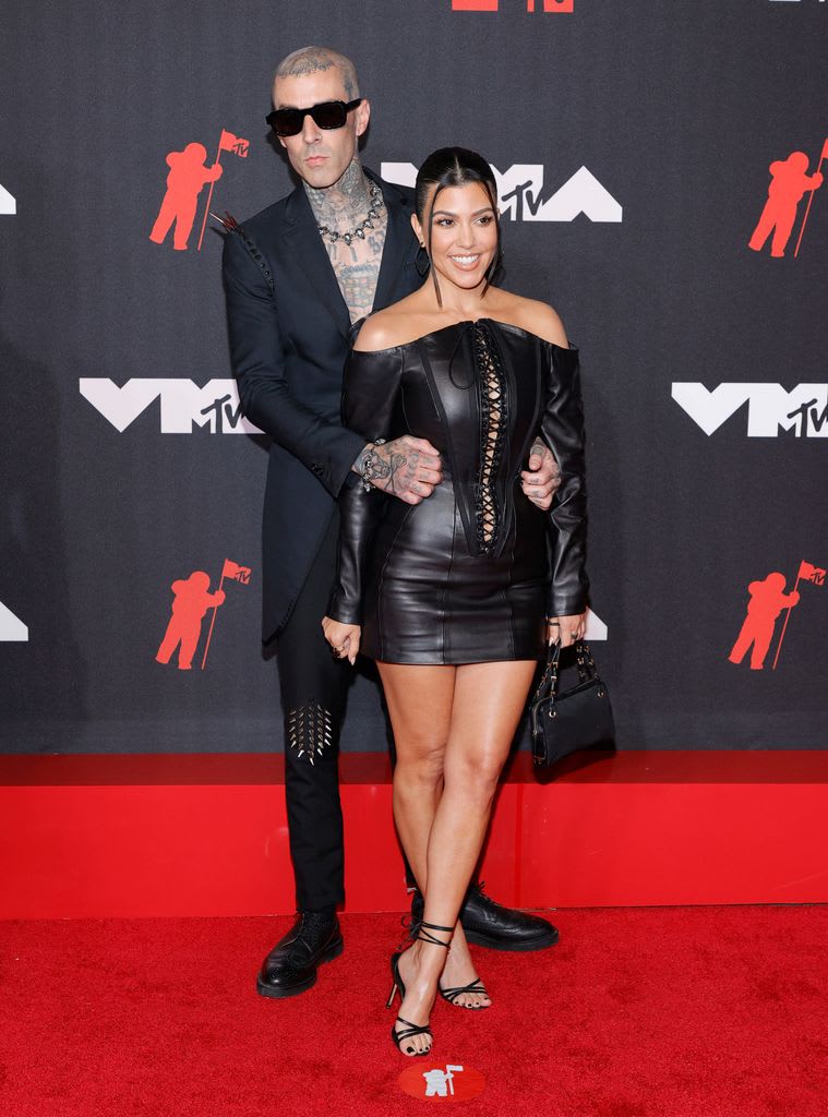 Travis Barker and Kourtney Kardashian on red carpet 