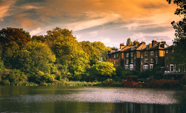 Scenic view of lake by buildings against sky during sunset,Hampstead Heath,London,United Kingdom,UK
